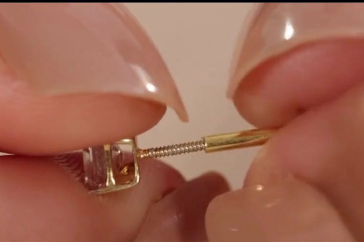 Fingers twisting the screw back onto a sleep stud